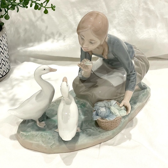 Lladró “Food for Ducks” Porcelain Figurine. Retired.